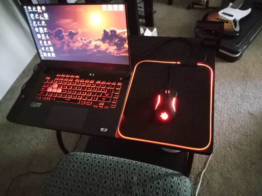 My little gaming area:) It ain't much, but the laptop has a 3050, so it's not crap by any means. I do hope to improve it one day.