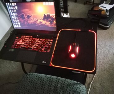 My little gaming area:) It ain't much, but the laptop has a 3050, so it's not crap by any means. I do hope to improve it one day.