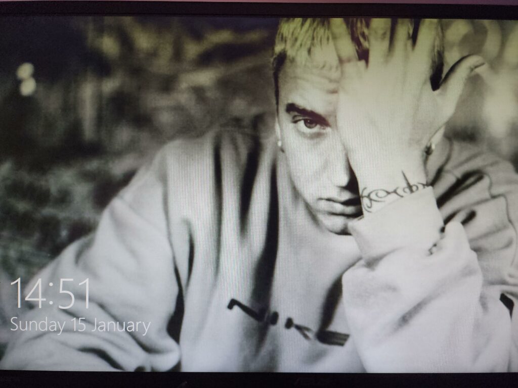 Everytime my PC restarts after an update, this photo of Eminem shows up om the lock page. after which it goes away. I have never set this photo as the lock screen, nor saved it in my pc