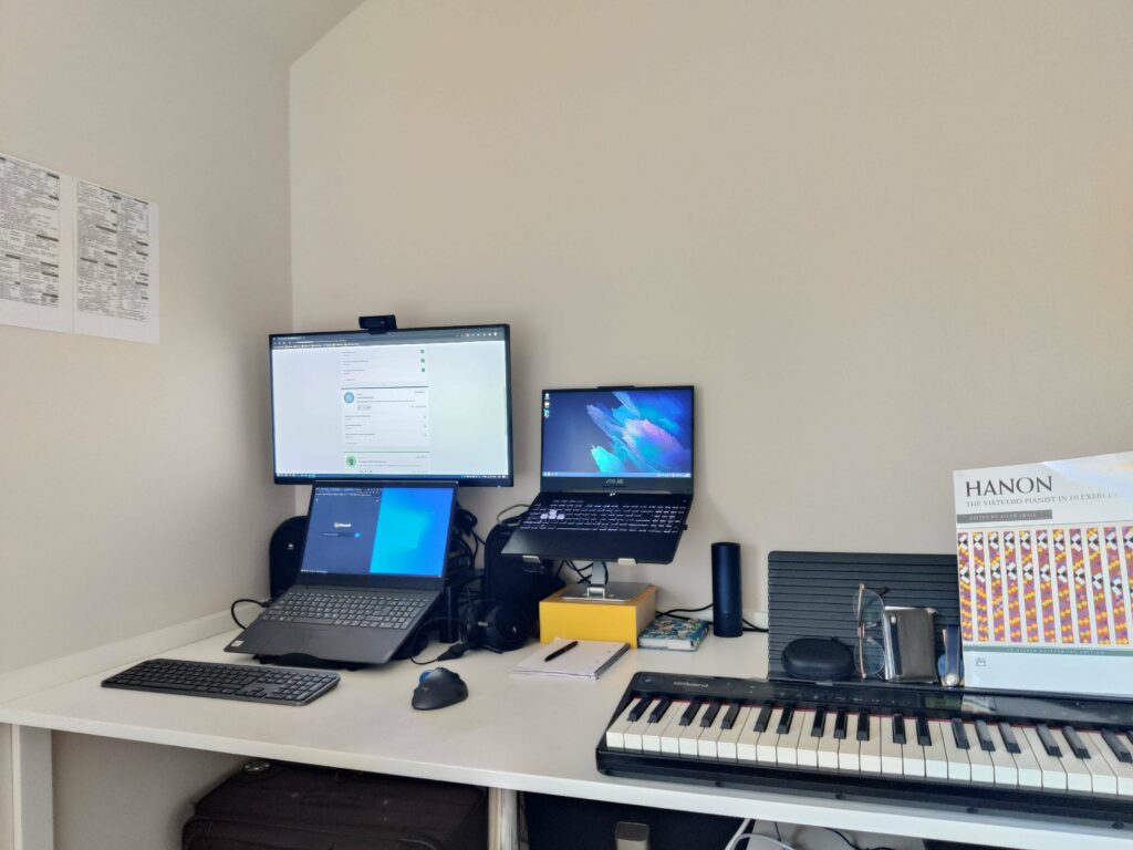 There are 5 more laptops stacked behind the keyboard