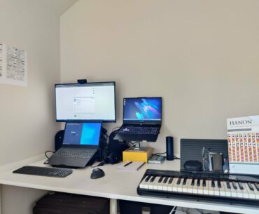 There are 5 more laptops stacked behind the keyboard