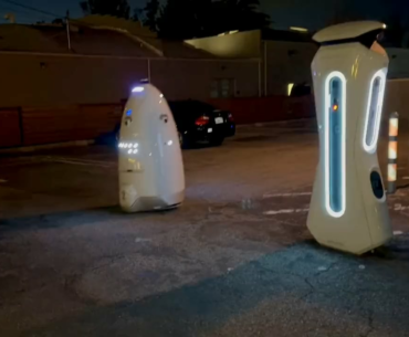 A security robot patrolling a parking lot at night in California.