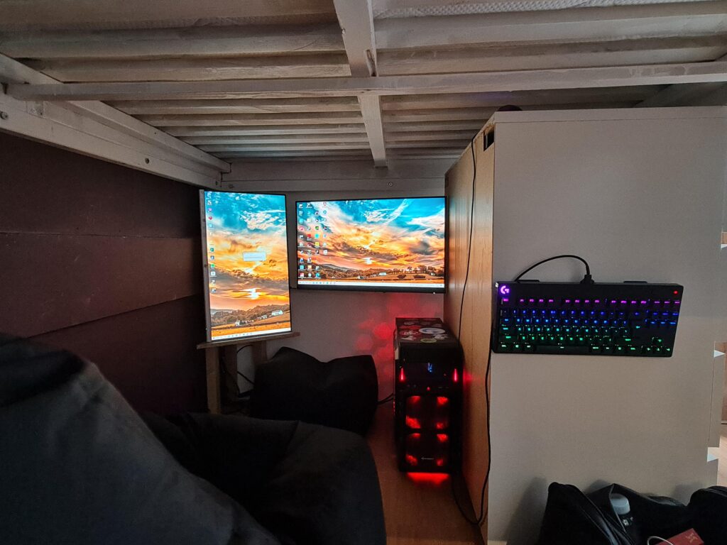 Battlestation under bed in tiny house.