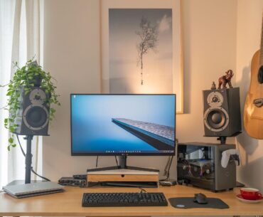 Have follow you guys' advice: Moved the computer away from under the guitar and got some actual monitor stands. Thanks for the input!