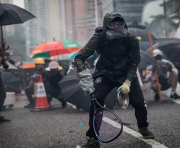 Protesters whip back tear gas with rackets (not mine)