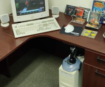 Rate my setup...and yes, this was taken in 2023. Celeron 400, 31 GB HD, Model M keyboard, 16" CRT, Logitech WingMan joystick, Altec Lansing speakers w/ sub, TrackMan mouse and a CompUSA mousepad.