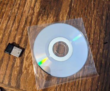 Help. My wireless adapter came with a small circular wafer. It has the product name on one side and a shiny film on the other. What am I supposed to do with it?