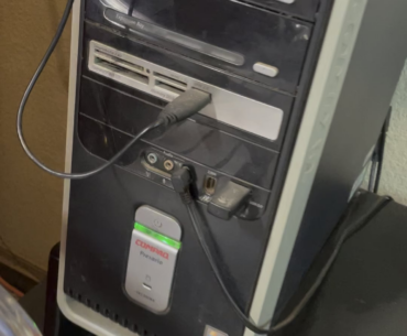 This super old PC still running in my neighbors garage they use to play music videos in the garage