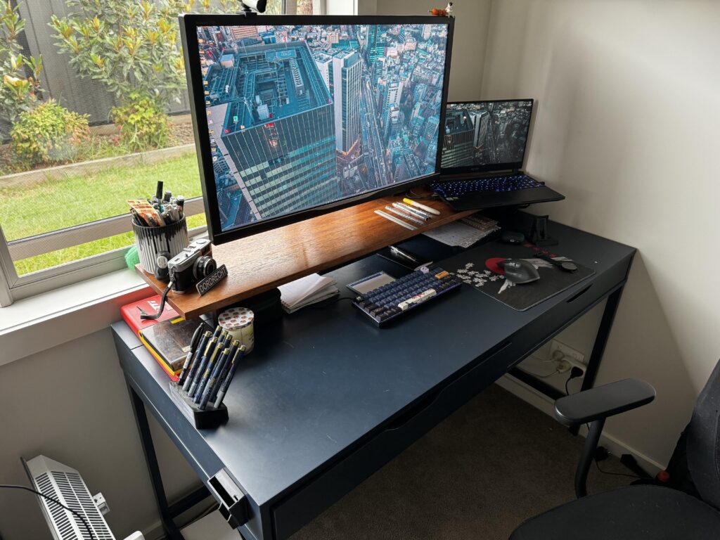 An IKEA Alex desk that finally suits a monitor mount (thanks to a plank of wood and cheap furniture feet)