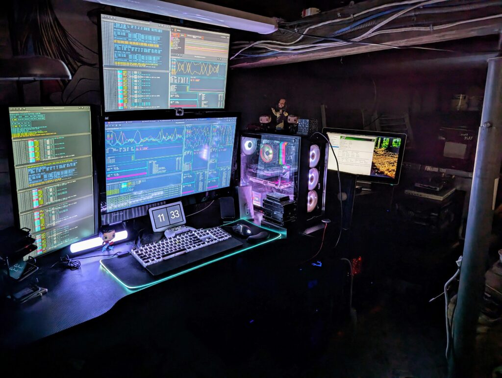 All lit up after getting cleaned up and organized. The tech nexus of my house. The far right monitor is attached to a different rig.