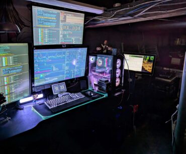 All lit up after getting cleaned up and organized. The tech nexus of my house. The far right monitor is attached to a different rig.