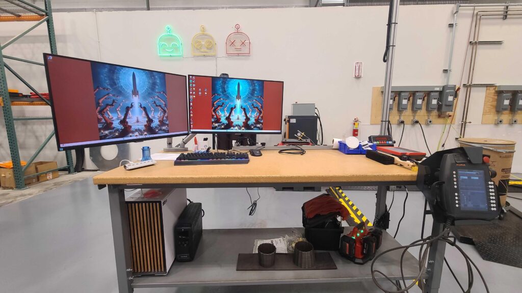 My $3,500,000 setup, $2K for a 7950X3d build in a fractal north case, and $3,498,000 for the custom 8-axis metal 3D printer. Yes this is my desk.