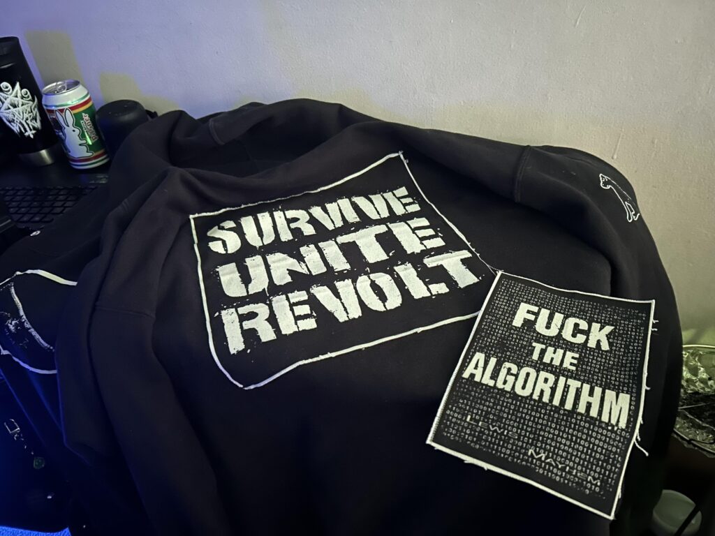Since there was a discussion about the “punk” part being missing from a lot of cyberpunk clothing earlier, here are some cool patches I picked up from a local artist recently that actually fit the bill