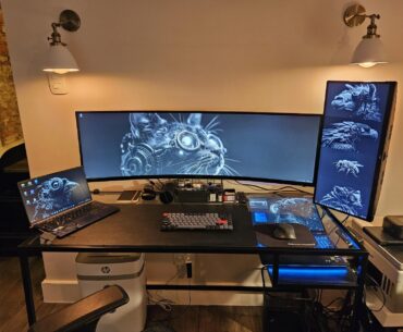 First-time poster. New setup (WFH). Finally decided to upgrade from a 4-yr old notebook and a 9-yr old 27” monitor. Needs a bit of cable management. [Thanks, u/sirgerg2 for sharing your artwork on r/WidescreenWallpaper.]