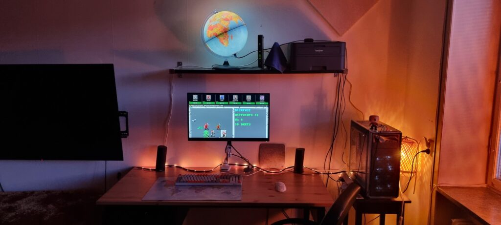 First timer: My cosy corner. I care a lot about light temperature. Pine desk, Fractal Design Focus G tower, Akko CS Jelly Purple keyboard. SSI:s "Curse of the Azure Bonds" onscreen.