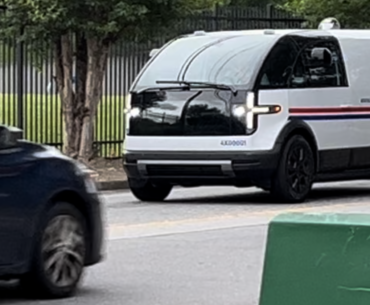 A rare sighting of a super cyberpunk Canoo mail truck, deployed as part of pilot program