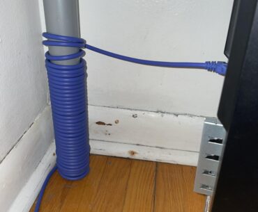 I have a very long Ethernet cable. Is it safe to have it wrapped around the leg of my desk like this?