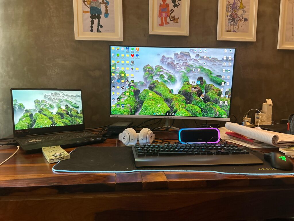 Laptop setup including a speaker and headphones