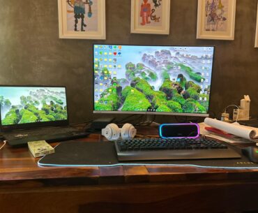 Laptop setup including a speaker and headphones