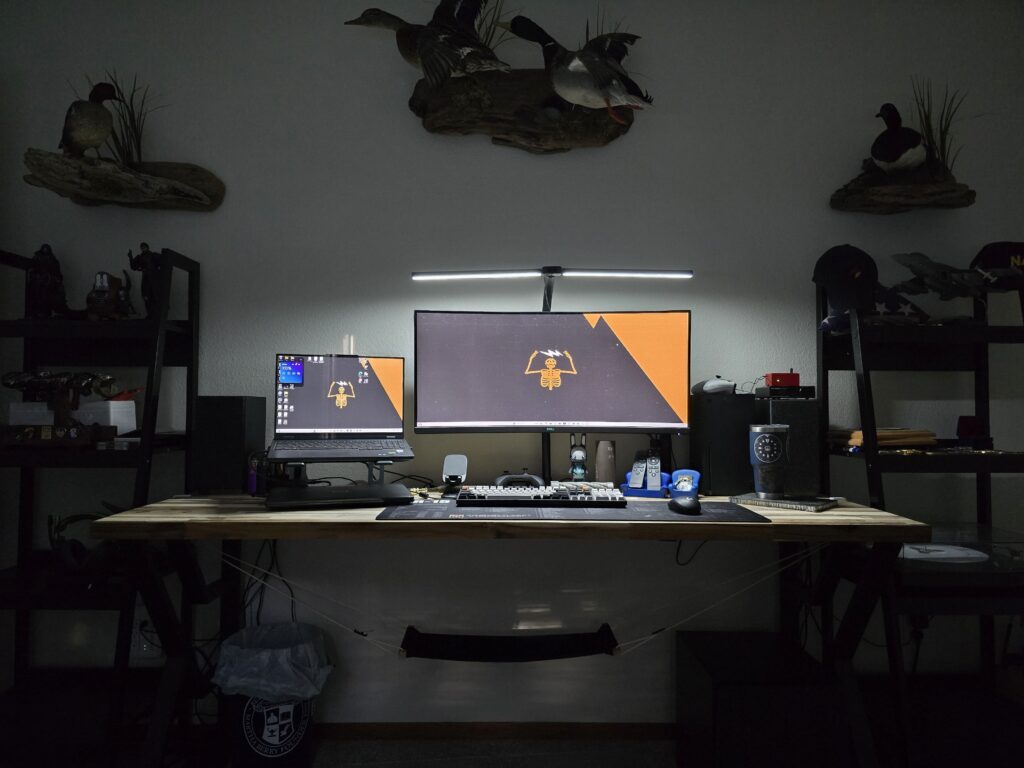 I'm pretty pleased with how my budget multi-use battlestation is coming along. Any suggestions on cable management for cables coming up from the surge protectors?