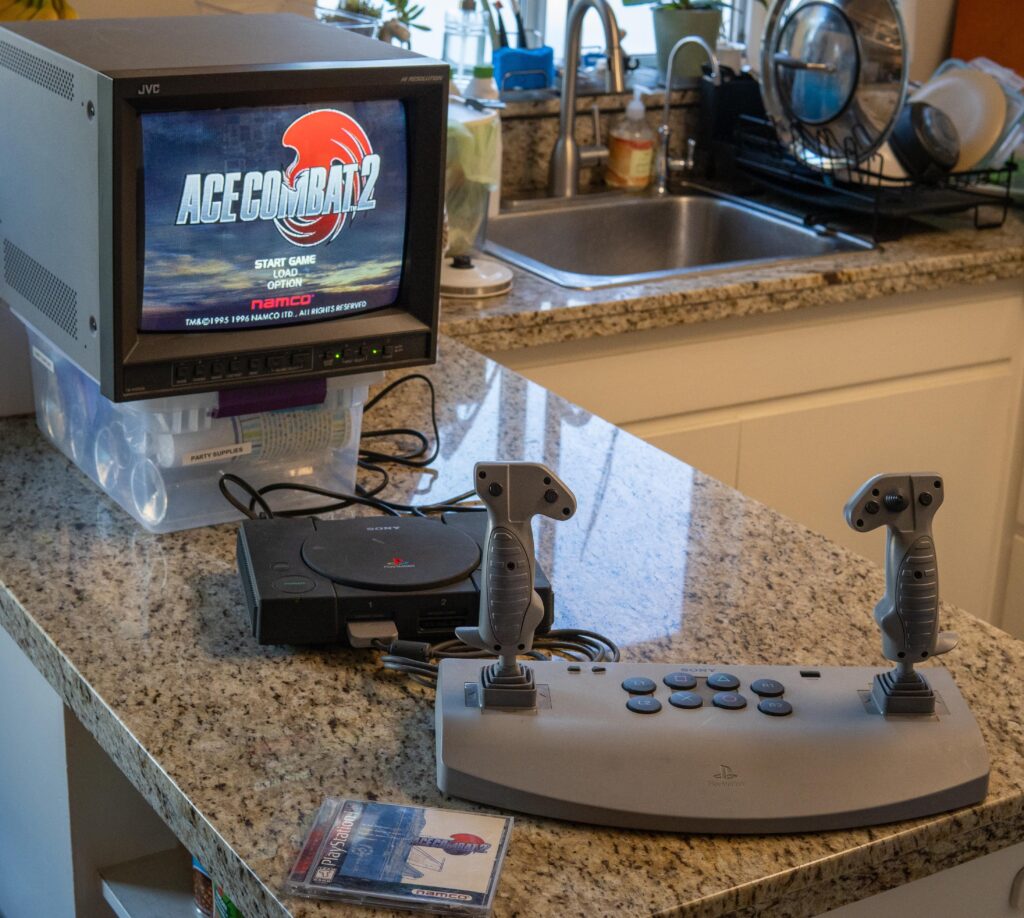 Three of the coolest items in my gaming collection: a JVC professional CRT monitor, a “Net Yaroze” PlayStation, and the Sony PlayStation Analog Joystick