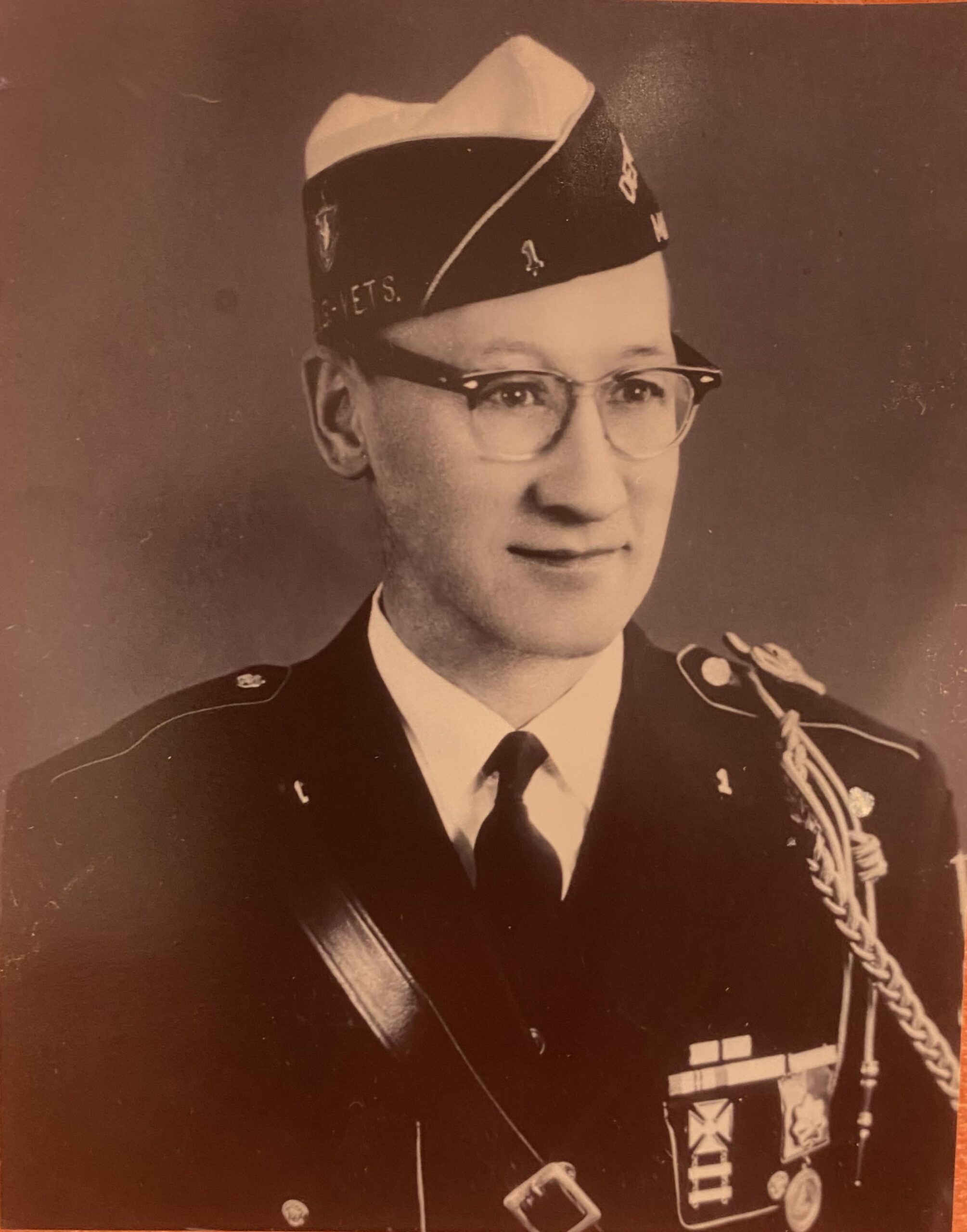 Found a picture of my great grandfather. Can anyone recognize the insignia on his uniform? I can see vet written on the cap, so he was in a war. He was born in 1902 and if he lied about his age he may have been in WWI as well. Any knowledge would be helpful. Thanks! Found a picture of my great grandfather. Can anyone recognize the insignia on his uniform? I can see vet written on the cap, so he was in a war. He was born in 1902 and if he lied about his age he may have been in WWI as well. Any knowledge would be helpful. Thanks!