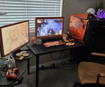 Orange/tiger-themed gaming/anime-watching battlestation. w/ an old school PC case and monitors. Part of a larger setup.