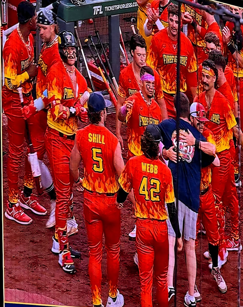 The Firefighters players embrace Nolan Hoffman, Graham Hoffman's brother.
