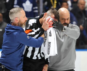 Referee Chris Rooney leaves NHL playoff game after being hit by stick