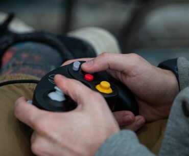 person holding a video game controller in their lap