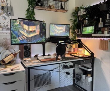 Space-efficient home office corner with dual monitors and pegboard organization