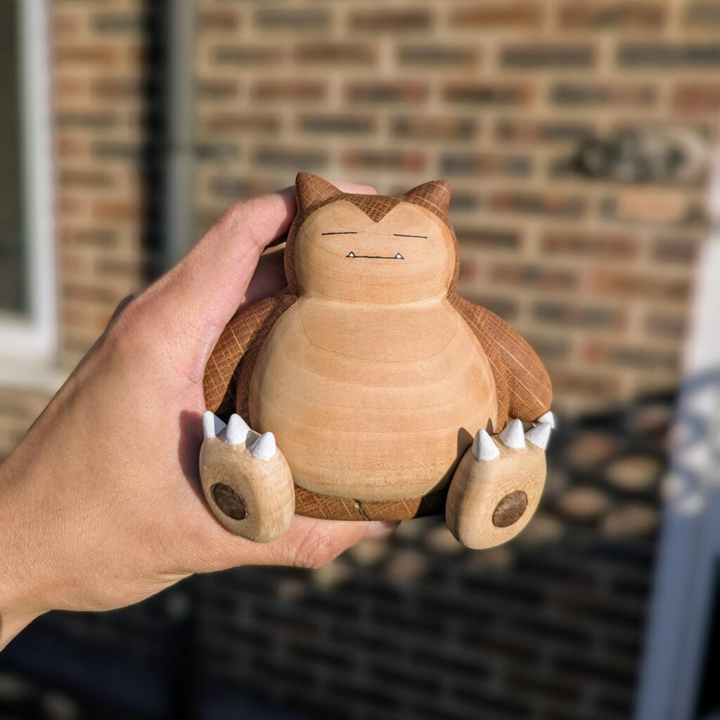 Hand carved a Snorlax out of oak, walnut, and basswood!