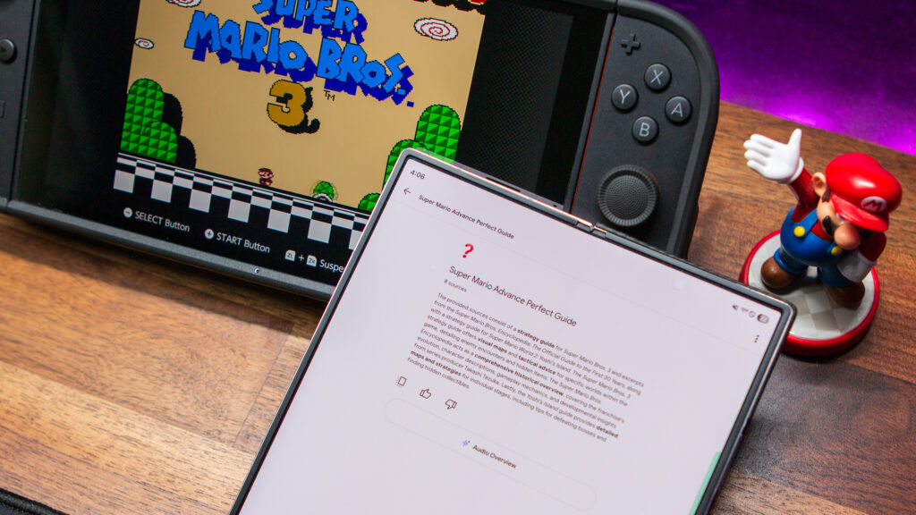 I stumbled upon the perfect reason to use Gemini and NotebookLM on a gaming handheld Mario guide within the NotebookLM app on the Galaxy Z Fold 6 with the Nintendo Switch 2 in the background