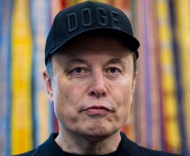 Elon Musk, chief executive officer of Tesla Inc., wears a "DOGE" hat during a news conference in the Oval Office of the White House in Washington, DC, US, on Friday, May 30, 2025. The event gives an opportunity for the president and his largest campaign benefactor to dispel any notion of an acrimonious divorce. Photographer: Francis Chung/Politico/Bloomberg via Getty Images
