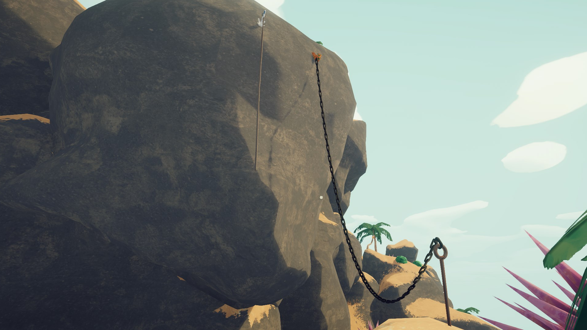 A chain and a rope hanging off of the side of a wall in Peak.