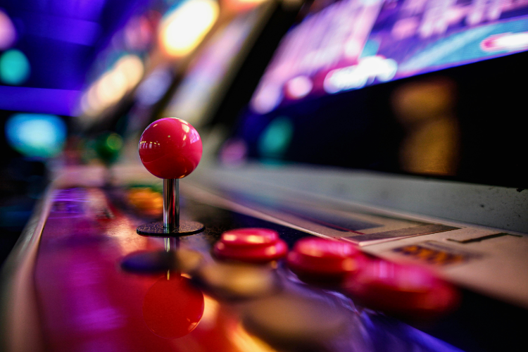 The Best Places for Gamers to Frequent in New Orleans close up of joystick and buttons on arcade game