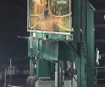 The patchwork construction of this structure with a pretty billboard promising a better future if you move into their new prohibitively expensive apartment building... Pretty cyberpunk to me