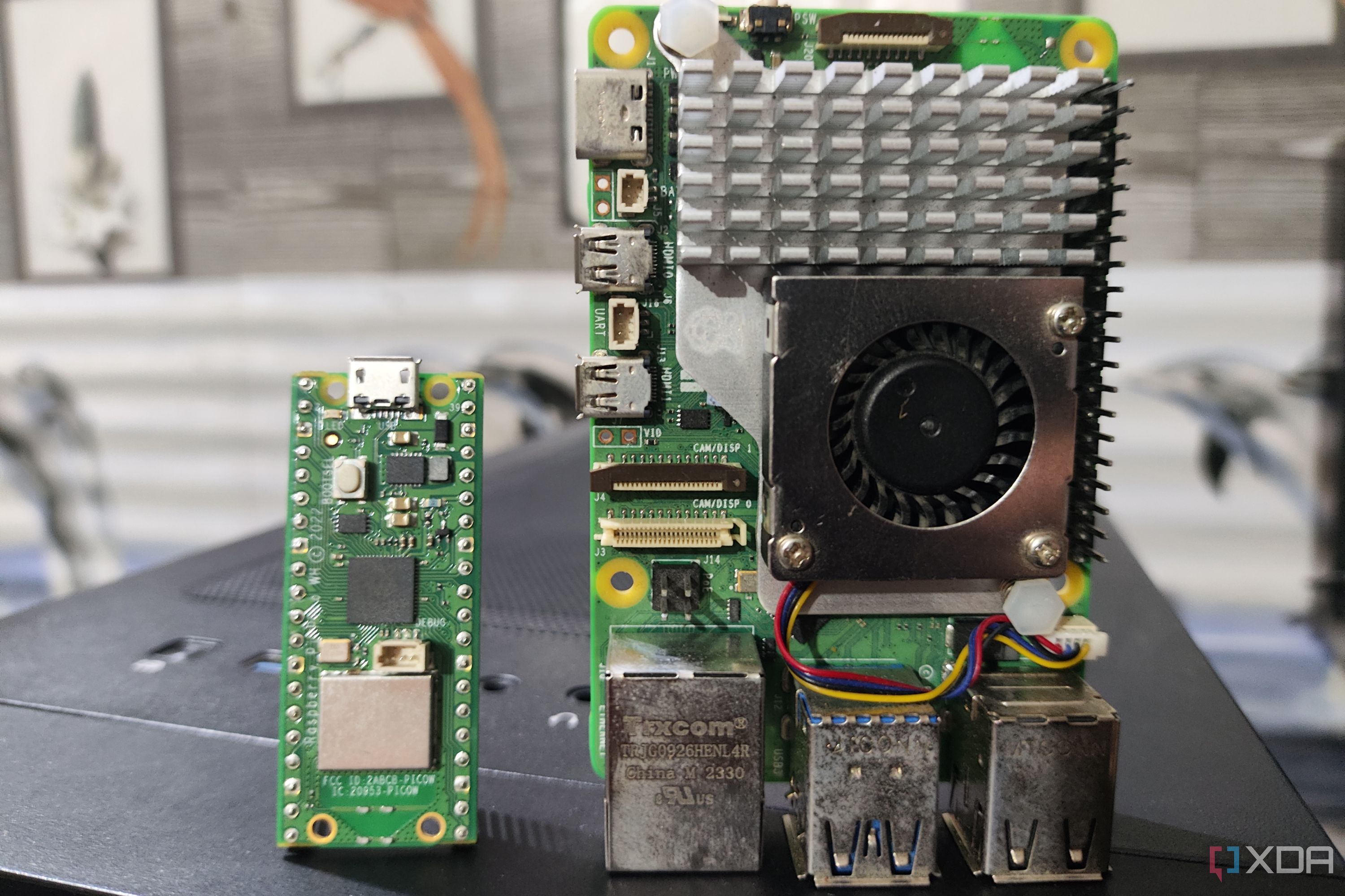A Raspberry Pi Pico placed next to a Raspberry Pi 5
