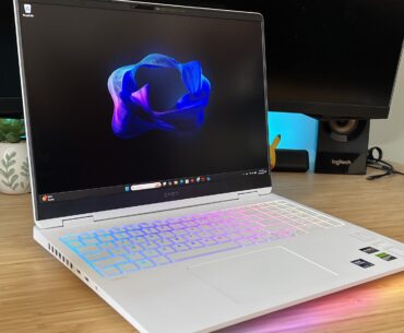 HP Omen Max 16 gaming laptop on a wooden desk with RGB lighting on