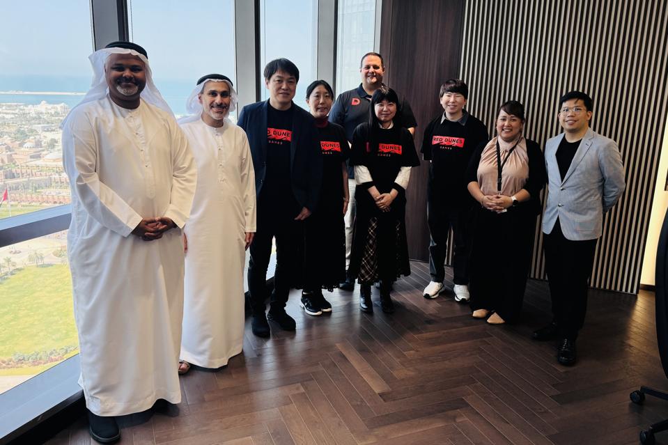 A group shot featuring Mohamed Jneibi and Sultan Darmaki (Red Dunes Games), Takuma Endo and Asami Nogawa (ACQUIRE Corp), Dave Audelo (Red Dunes Games), Akie Nakao and Masamitsu Yamada (ACQUIRE Corp), and Jaedie Mabita and Aljed Marquez (Red Dunes Games).
