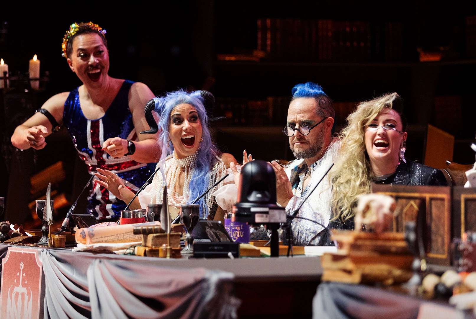 Left to right, Sam Riegel, Laura Bailey, Taliesin Jaffe, and Ashley Johnson on stage in London in October 2023. During the Wembly Arena show they wore elaborate costumes, including Riegel’s Union Jack onesie.