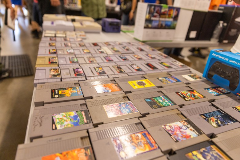 Rows of retro NES cartridges displayed on a vendor table at the Stockton Gamer Festival, featuring classic titles and collectibles.