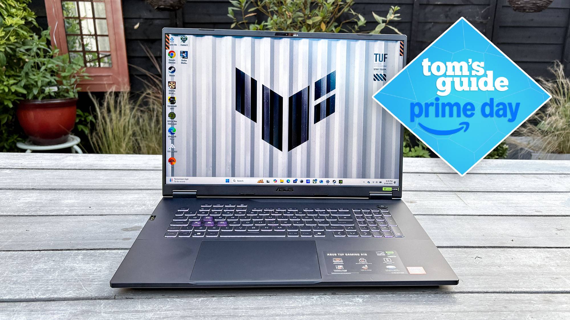 Asus TUF Gaming A18 on table outside with Tom's Guide Prime Day badge