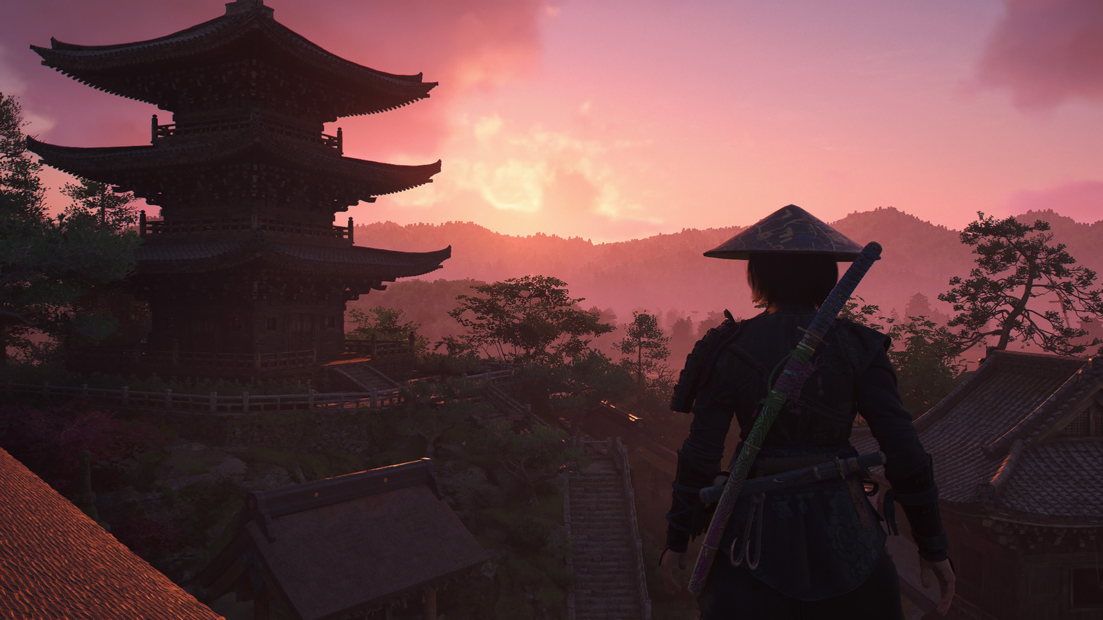 Naoe watching red skies as the sun sets behind a shrine in Assassin's Creed Shadows