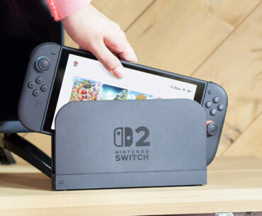 A Switch 2 being removed from its dock.