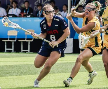 Cassidy Weeks looks for an avenue to drive through Australia's defense in lacrosse action at The World Games in China
