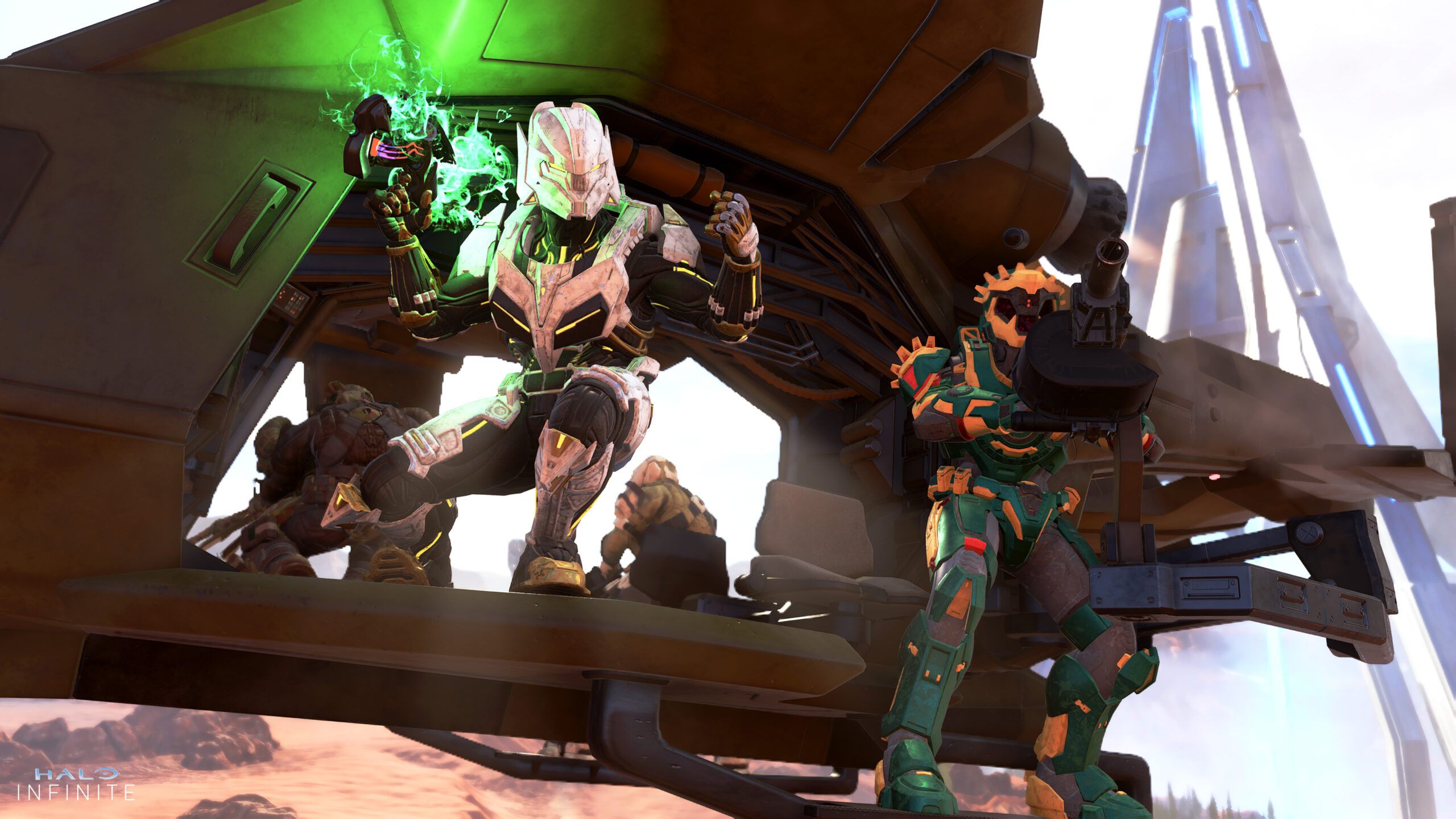 Four Spartans ride in the back of a Falcon. On the visible left side, a Spartan in Aristos armor cheers in triumph, holding a smoldering Plasma Pistol near an ally in Fire Serpent armor aiming a grenade launcher turret.
