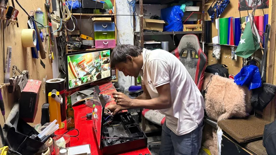 A joystick is repaired at the Maniax arcade. - Javed Iqbal/CNN