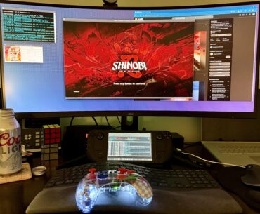 My new Steam Deck battlestation, with a controller my daughter gave me as a gift.