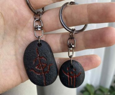 My friend made me these cool Bloodborne rune keychains using river stones!
